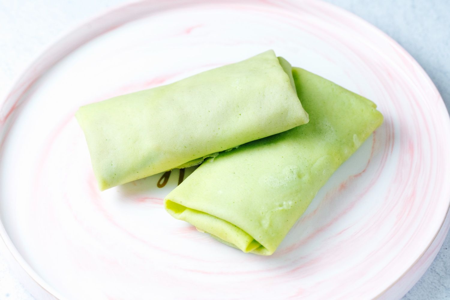 front-view-light-green-rolled-pancakes-plate